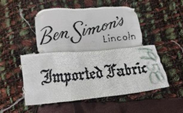Clothing labels reading "Ben Simon's Lincoln" and "Imported Fabric" on textured fabric.